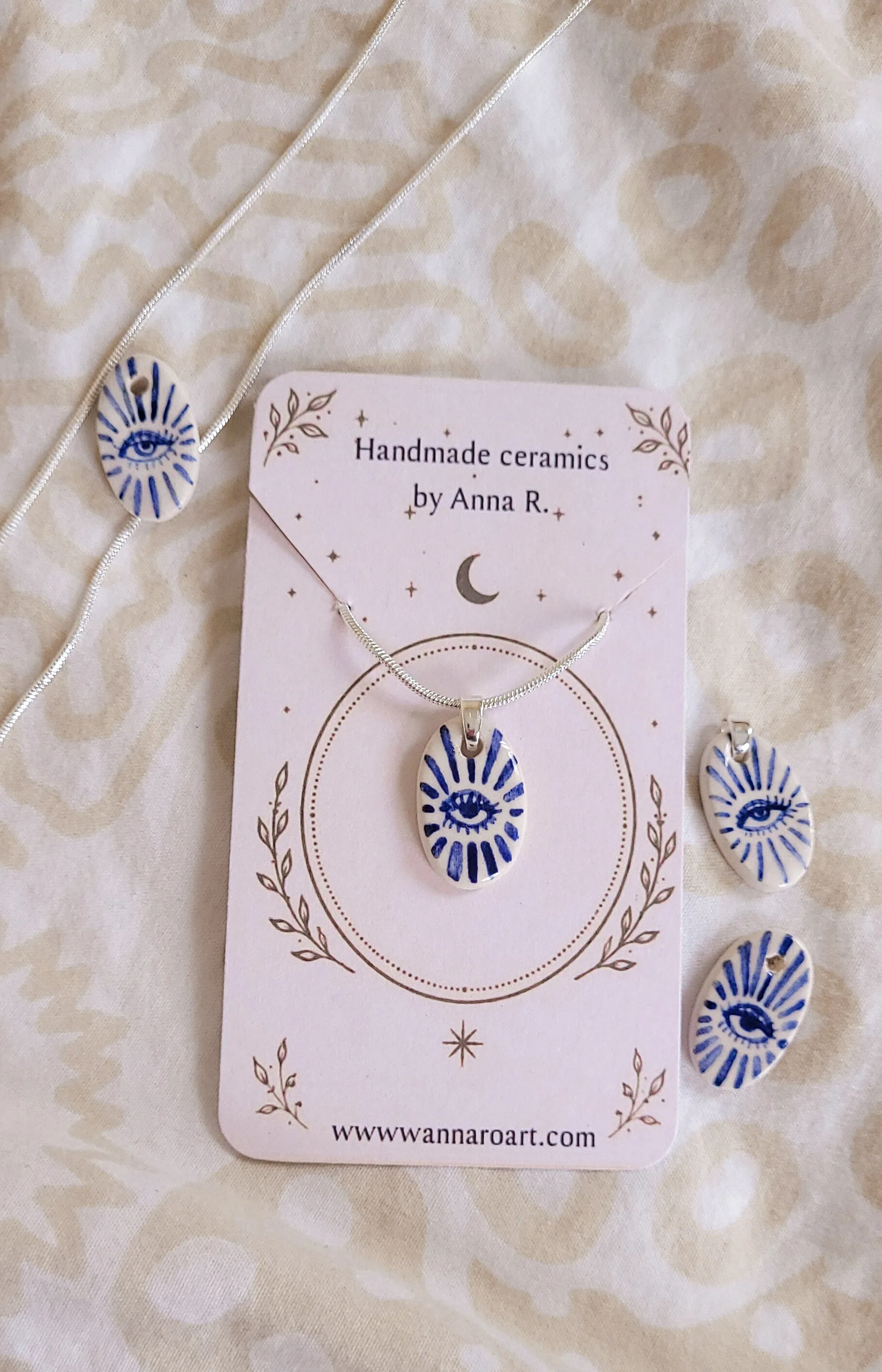 Eye ceramic pendant on silver chain